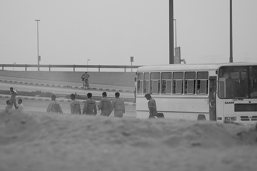 Labourers exiting a bus